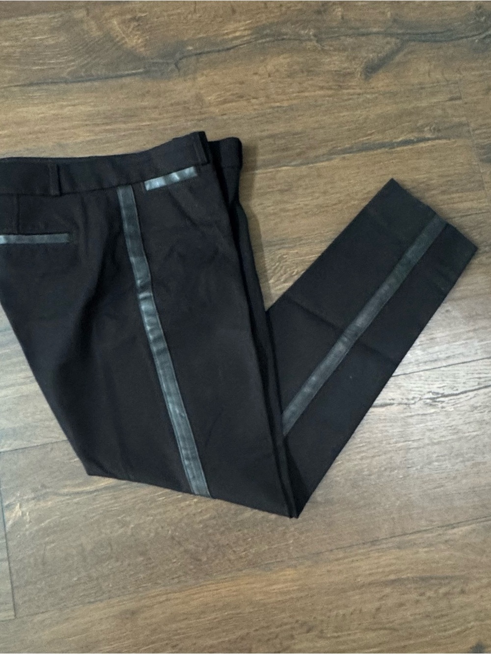 Chic black tuxedo‑inspired trousers featuring a sleek faux‑leather side stripe a